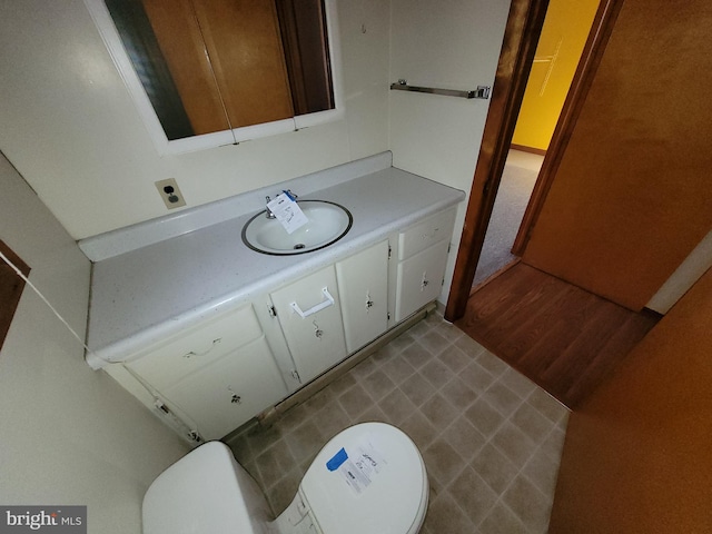 bathroom with vanity, hardwood / wood-style flooring, and toilet