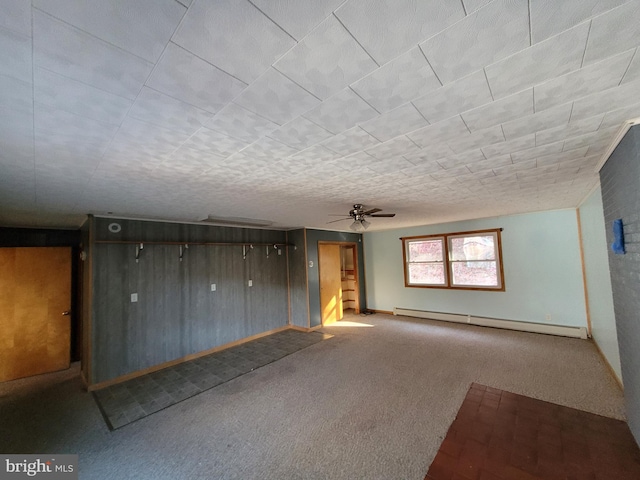 spare room featuring baseboard heating, ceiling fan, and carpet