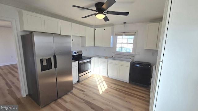 kitchen with white cabinetry, a ceiling fan, appliances with stainless steel finishes, light wood finished floors, and decorative light fixtures