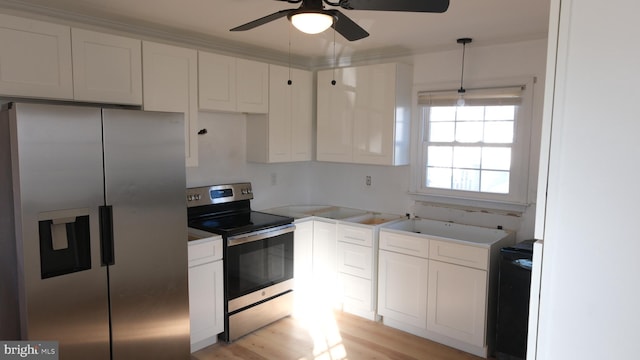 kitchen featuring pendant lighting, appliances with stainless steel finishes, light wood-style floors, white cabinetry, and ceiling fan