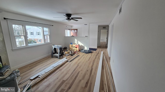 living room featuring light hardwood / wood-style floors and ceiling fan