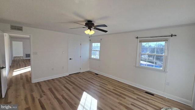 unfurnished bedroom with light wood finished floors, visible vents, and baseboards