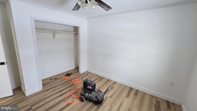 unfurnished bedroom featuring a closet, wood finished floors, and baseboards