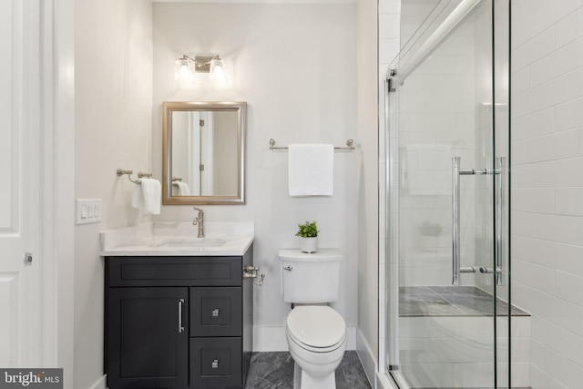 bathroom with vanity, toilet, and an enclosed shower