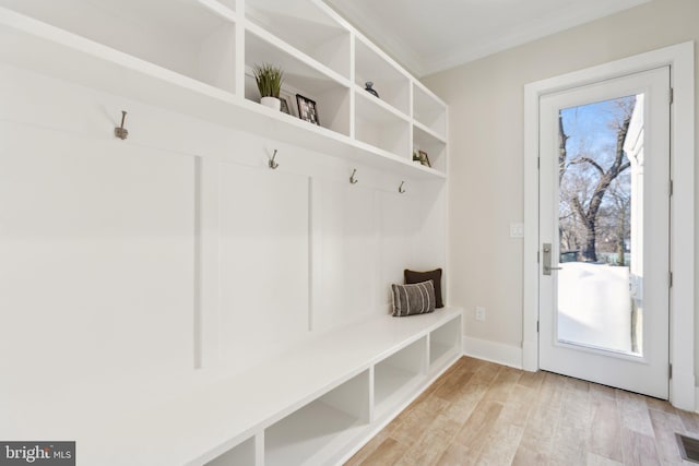 mudroom with crown molding and light hardwood / wood-style flooring