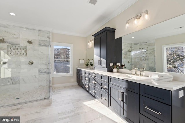 bathroom with vanity, a shower with shower door, and ornamental molding