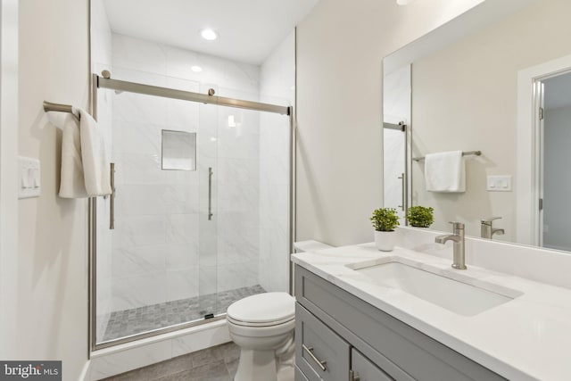 bathroom with vanity, toilet, and walk in shower