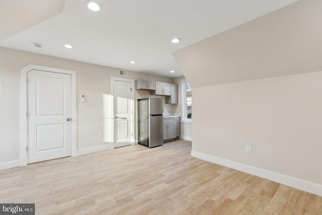 unfurnished living room with light hardwood / wood-style flooring