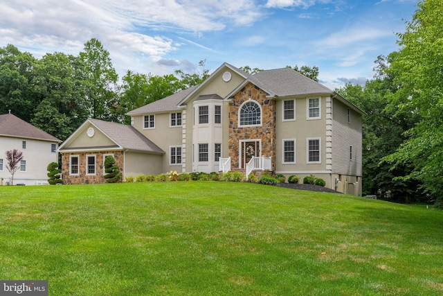 colonial-style house with a front lawn