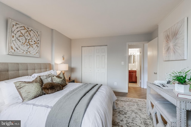 bedroom featuring a closet, connected bathroom, and light parquet floors