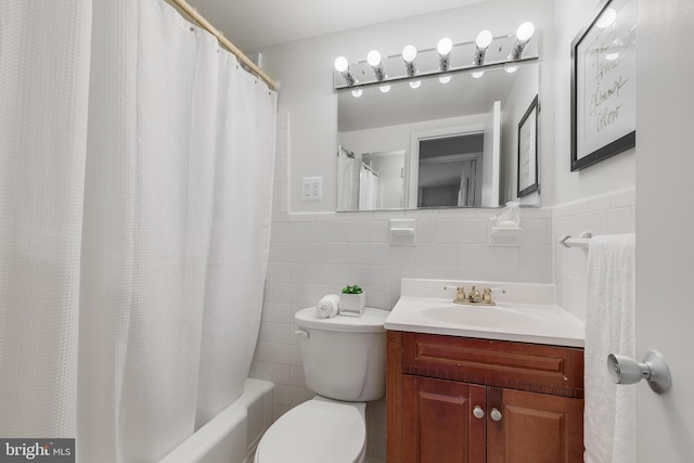 full bathroom with shower / tub combo, vanity, toilet, and tile walls