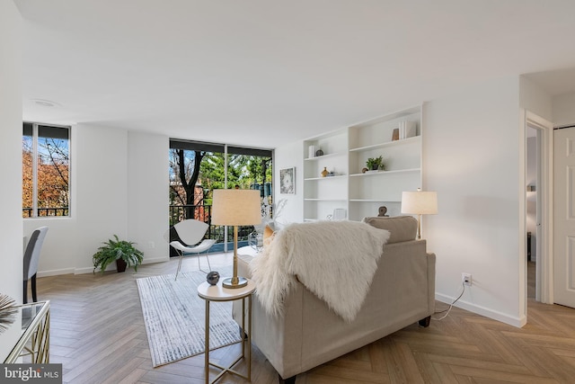 living room featuring a wealth of natural light and light parquet flooring