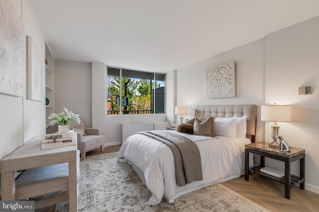 bedroom featuring light parquet floors