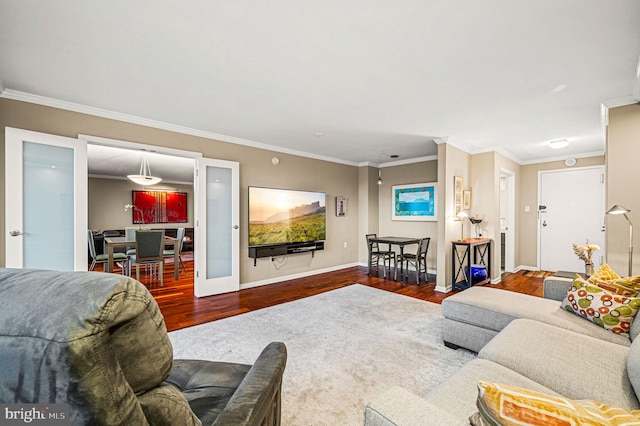 living room featuring french doors, hardwood / wood-style flooring, and crown molding