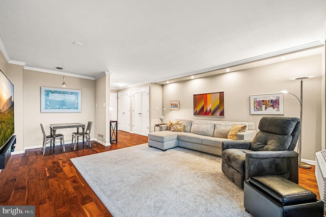 living room featuring dark hardwood / wood-style floors and crown molding