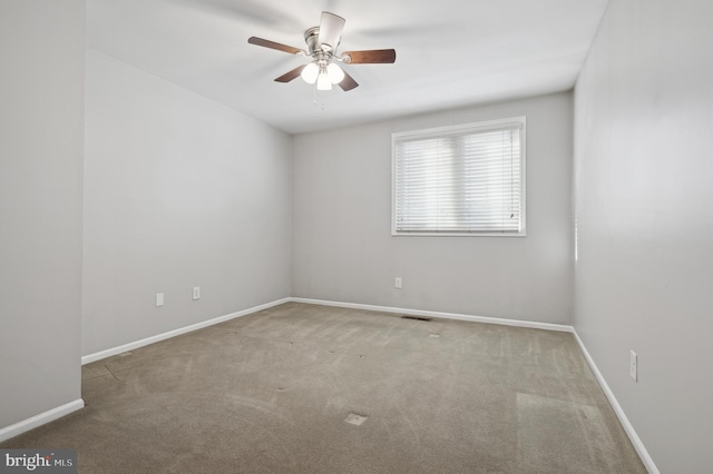 carpeted spare room with ceiling fan