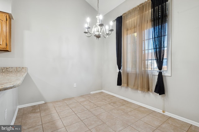 unfurnished dining area featuring lofted ceiling, a notable chandelier, and light tile patterned flooring