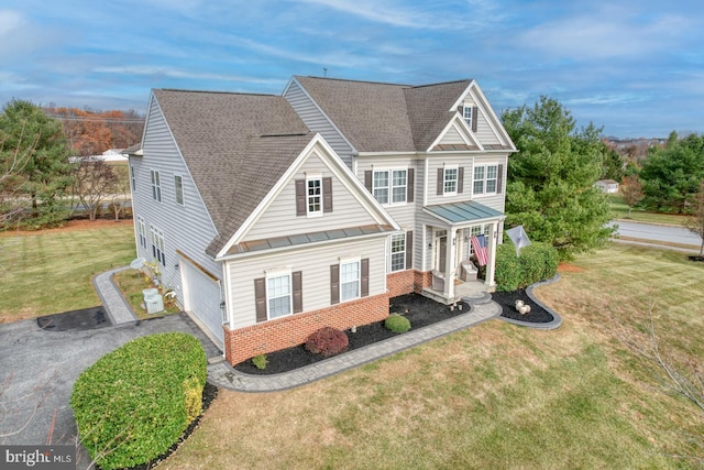 view of front facade featuring a porch, a garage, and a front yard