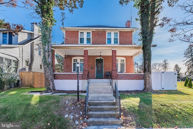 view of front of property with a front lawn and a porch