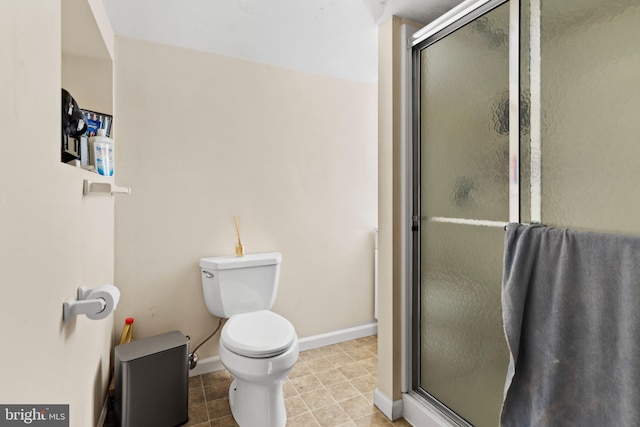 bathroom featuring tile patterned floors, toilet, and walk in shower