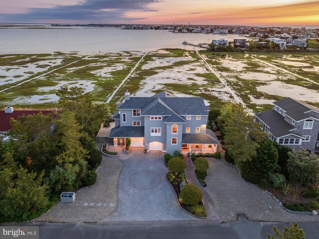 aerial view at dusk with a water view