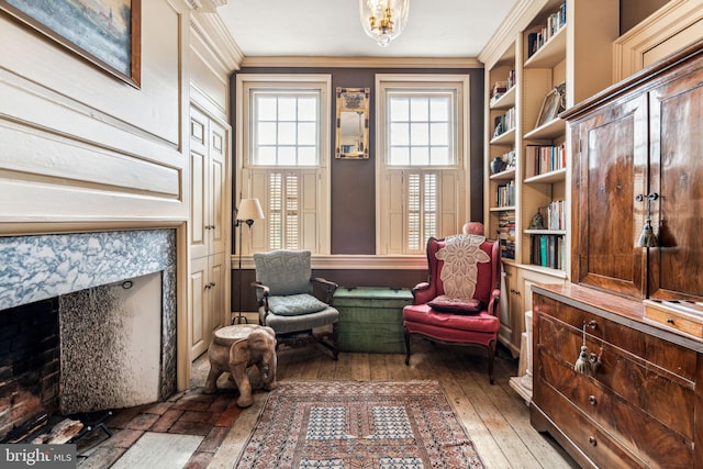 sitting room featuring crown molding and dark wood-type flooring