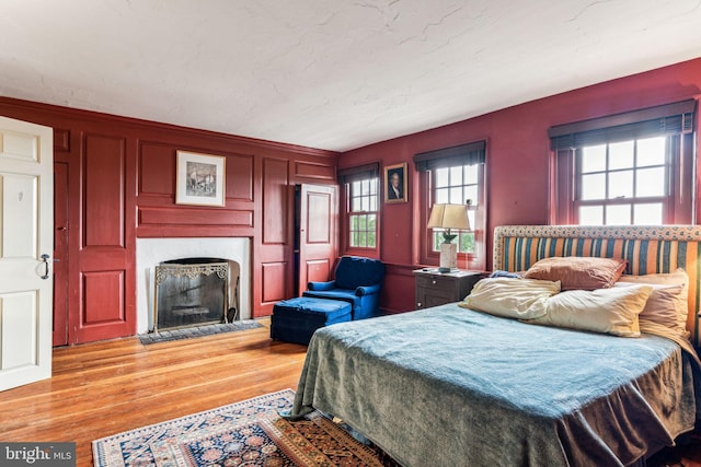 bedroom featuring light wood-type flooring and multiple windows