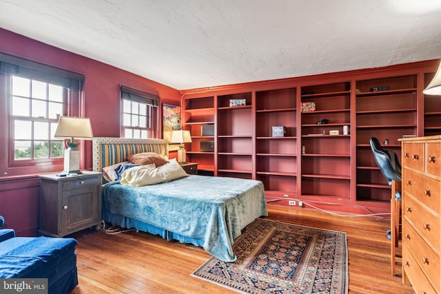 bedroom featuring light wood-type flooring and a textured ceiling