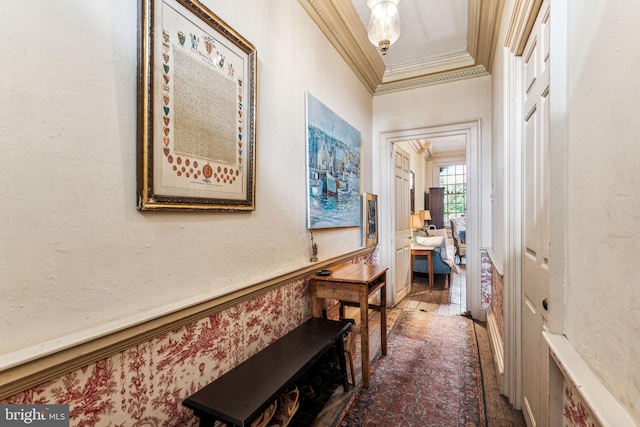 hall with wood-type flooring and ornamental molding