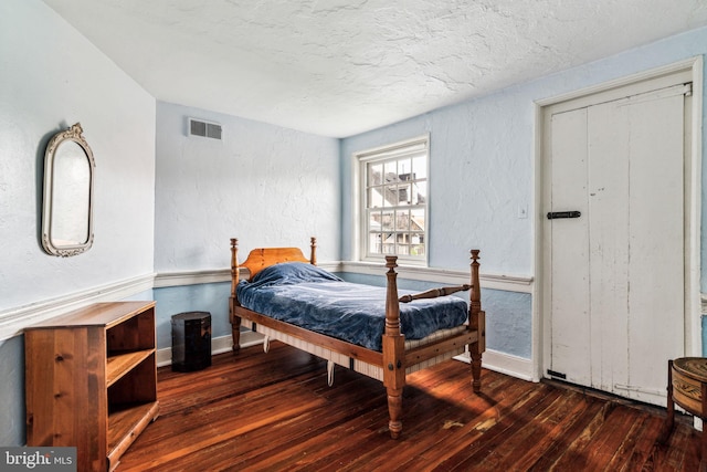 bedroom featuring dark hardwood / wood-style floors