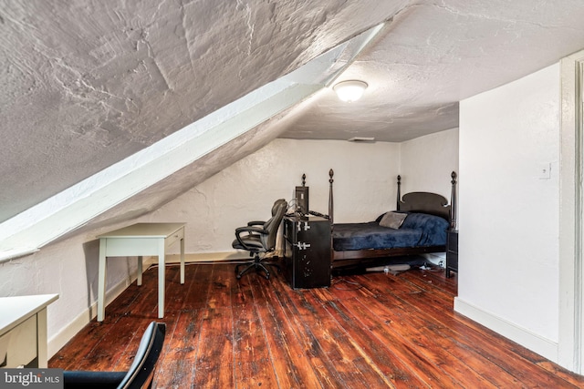 bedroom featuring dark hardwood / wood-style flooring and vaulted ceiling