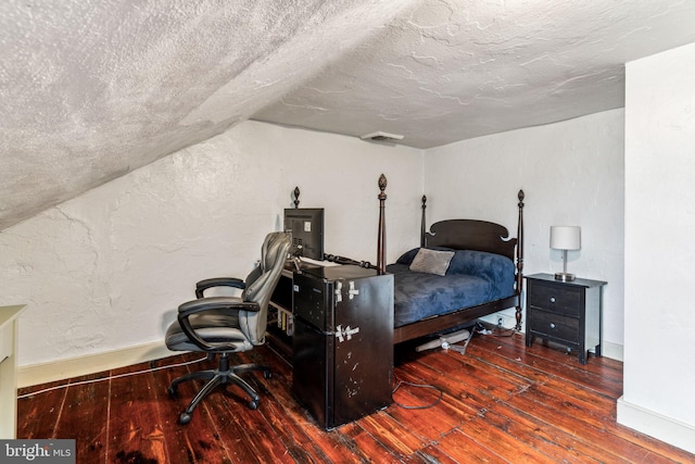 bedroom featuring a textured ceiling, wood-type flooring, and lofted ceiling