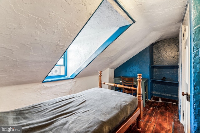 bedroom with dark wood-type flooring and vaulted ceiling