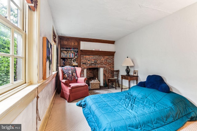 bedroom with a brick fireplace