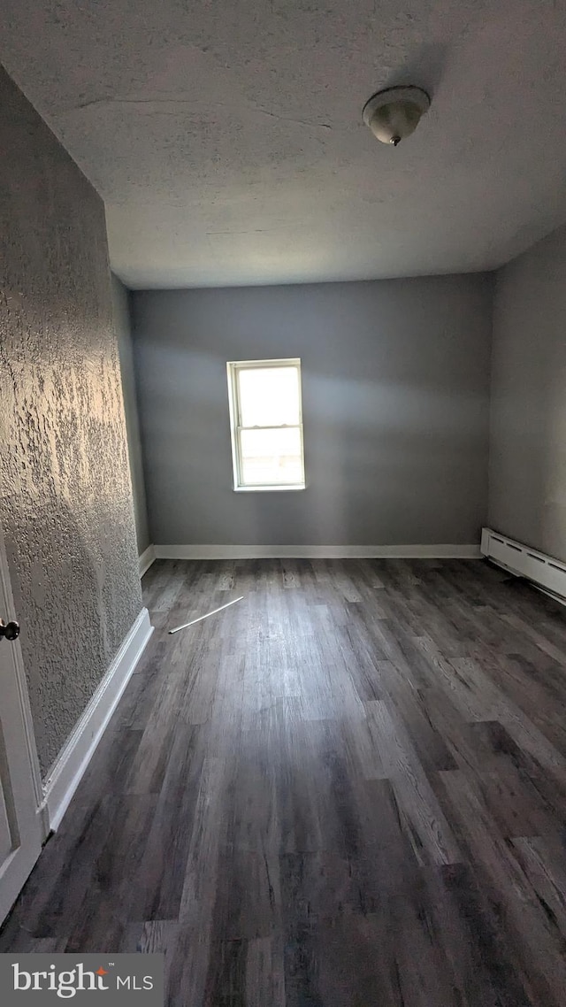 spare room with dark hardwood / wood-style flooring