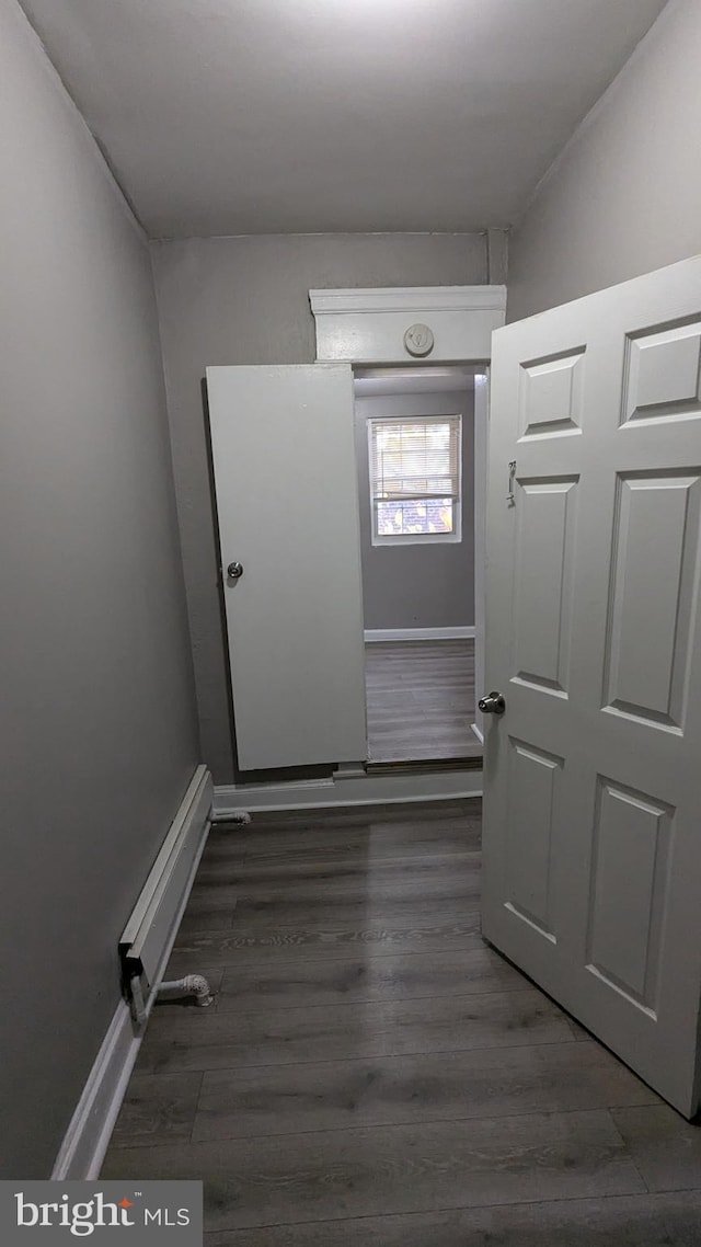 hall featuring lofted ceiling and dark hardwood / wood-style floors