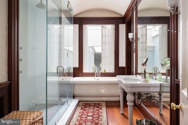 bathroom with hardwood / wood-style floors and separate shower and tub