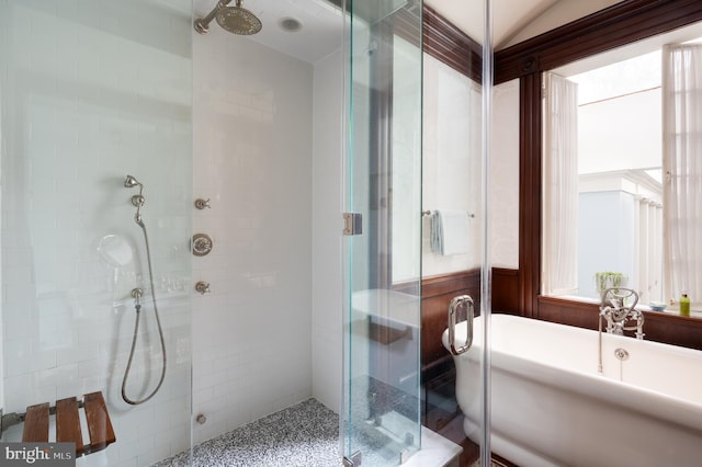 bathroom featuring wood walls and plus walk in shower