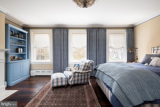 bedroom with dark hardwood / wood-style flooring, a baseboard radiator, and ornamental molding