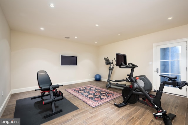 exercise room featuring hardwood / wood-style floors