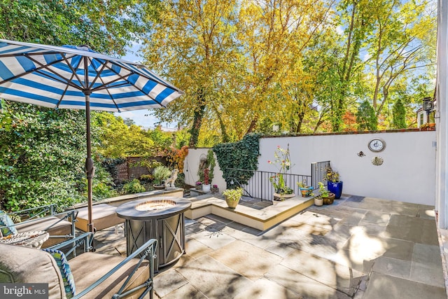 view of patio / terrace with an outdoor fire pit