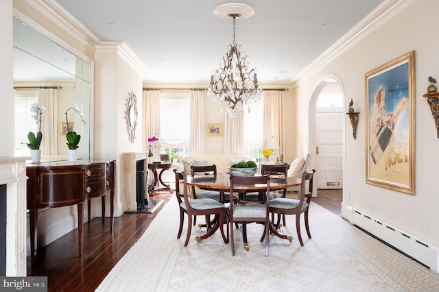 dining space featuring wood-type flooring, plenty of natural light, baseboard heating, and crown molding