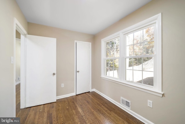 unfurnished bedroom featuring dark wood-type flooring