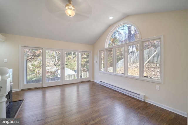 interior space with dark hardwood / wood-style flooring, a baseboard radiator, vaulted ceiling, and plenty of natural light