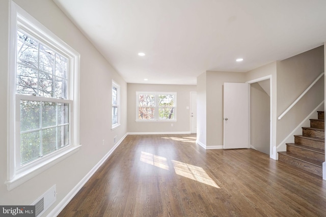 unfurnished living room with dark hardwood / wood-style flooring