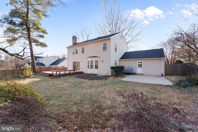 back of property with a patio area, a yard, and a deck