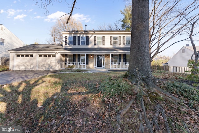 colonial house featuring a garage and covered porch