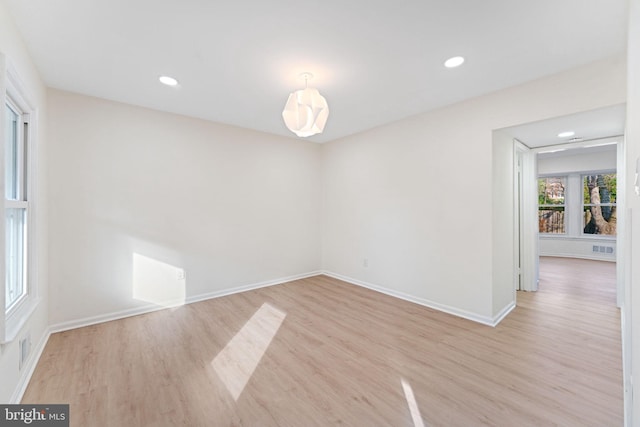 spare room with light hardwood / wood-style flooring