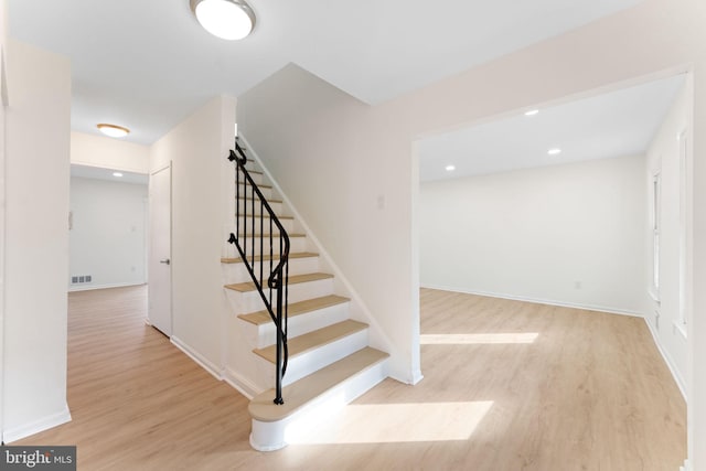 staircase featuring hardwood / wood-style flooring