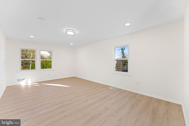 empty room featuring light hardwood / wood-style floors and a healthy amount of sunlight